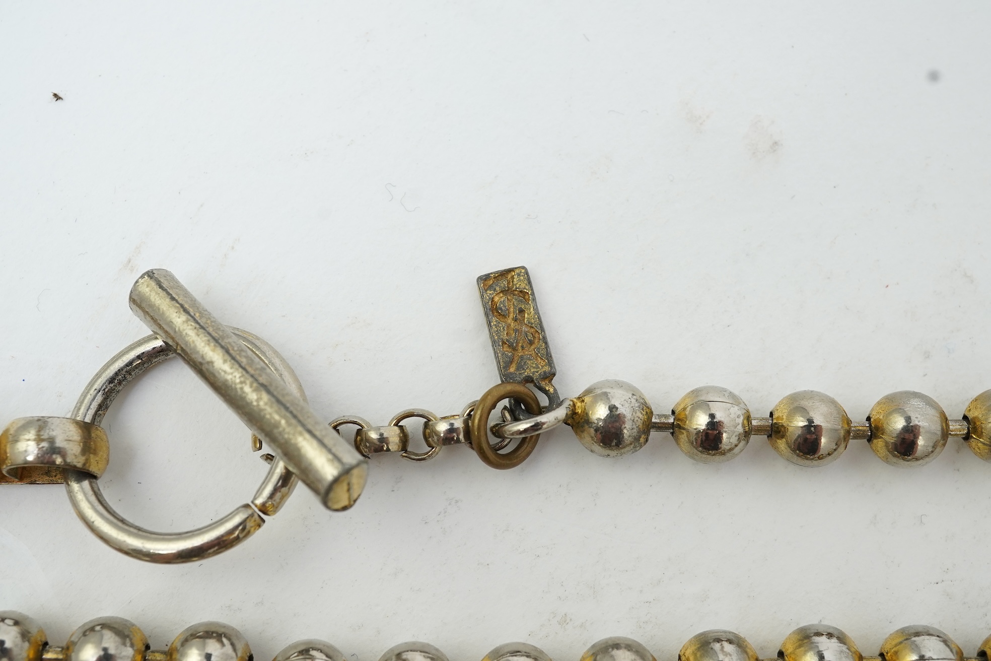 A collection of jewels and accessories including a Russian icon, comprising: a white glass bead rosary; a gilt metal and paste sacred heart motif for wall mounting, length 15.5cm; a gilt metal cube-shaped Nepro alarm clo